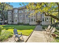 Apartment building exterior with a well-maintained lawn, mature trees and attractive architectural details at 1156 Piedmont Ne Ave # B3, Atlanta, GA 30309