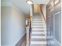Inviting entryway with staircase and gray wood flooring leading into the home at 2340 Beaver Ruin Rd # Un62, Norcross, GA 30071