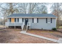 Charming single-story home featuring a cozy front porch and classic architectural details at 112 Oakland Blvd, Stockbridge, GA 30281