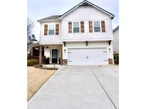 Charming two-story white home with wooden shutters and a spacious two-car garage, complemented by a concrete driveway at 2626 Chase Rdg, Kennesaw, GA 30144
