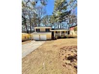 Charming two-story home with a well-maintained lawn and inviting front porch at 6061 Tina Ln, Rex, GA 30273