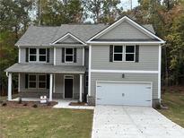 Charming two-story home with a gray exterior, complemented by a well-manicured front yard at 1102 Campbell Rd, Covington, GA 30014