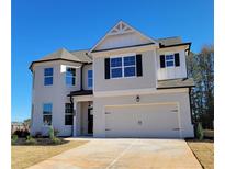 Charming two-story home with a two-car garage and well-manicured front yard at 472 Eagles Nest Cir, Auburn, GA 30011