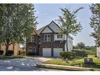 Charming two-story home with a two-car garage and well-maintained landscaping at 907 Southfork Dr, Loganville, GA 30052