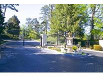 A beautiful stone entrance gate with mature landscaping and a fountain welcomes you to the community at 1112 Pine Heights Ne Dr, Atlanta, GA 30324