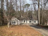 Charming ranch style home with mature trees, a long driveway and neutral siding at 5073 Willow Point Pkwy, Marietta, GA 30068