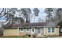 Charming single-story home with a brick and tan exterior and well-maintained front yard at 96 Sir Scott Ct, Lawrenceville, GA 30044