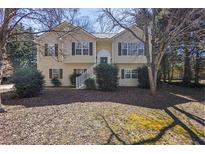 Charming two-story home with a welcoming front yard and inviting staircase entry at 255 N Loblolly Xing, Temple, GA 30179