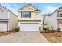 Charming two-story home with neutral siding, attached two-car garage, and well-manicured landscaping at 5935 Mountain Top Pl, Cumming, GA 30041