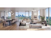 Bright and airy living room featuring hardwood floors, modern furnishings, and large windows showcasing city views at 2425 Peachtree Rd # 1806, Atlanta, GA 30305