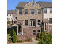 Charming brick townhome featuring a covered entry, and wrought iron railings at 414 Montclair Ct, Woodstock, GA 30188