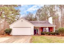 Charming single-story home with a manicured lawn, two-car garage, and inviting entrance at 122 Lakepointe Court, Stockbridge, GA 30281