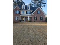 Charming two-story brick home with black shutters and a well-manicured front yard at 190 Holcomb Ct, Fayetteville, GA 30215