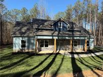 Charming light blue home with stone accents, well manicured lawn, and inviting front porch at 2117 Hwy 101 N, Dallas, GA 30157