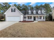 Charming single-Gathering home with a well-manicured lawn, two-car garage, and inviting front porch at 2229 Saint Kennedy Ln, Buford, GA 30518