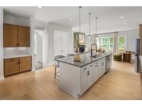 Bright kitchen features a large island with seating, modern appliances, and an open floor plan at 1424 Wicker Wood Se Pl # 7, Smyrna, GA 30080