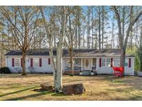 Charming single-story home with a welcoming front porch, red shutters, and a spacious front yard at 6106 Misty Valley Se Dr, Acworth, GA 30102