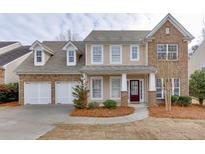 Charming two-story home featuring a two-car garage, brick accents and a welcoming front porch at 2341 Walnut Tree Ct, Buford, GA 30519