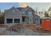 Beautiful two-story brick home with an attached two-car garage in a serene, wooded setting at 3686 Thornhill Ct, Douglasville, GA 30135