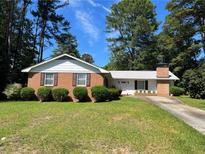 Charming one-story brick home featuring manicured landscaping and a classic design at 5336 David Cir, Covington, GA 30014