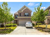 Charming two-story brick home with well-maintained lawn and attached garage at 1749 Charcoal Ives Rd, Lawrenceville, GA 30045