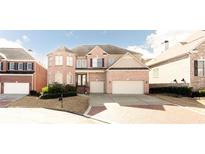 Traditional brick home with a two-car garage and well-manicured landscaping at 2322 Norbury Se Cv, Smyrna, GA 30080