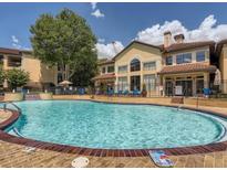 Beautiful pool surrounded by lush landscaping and a well-maintained apartment complex on a bright, sunny day at 3777 Peachtree Ne Rd # 1324, Brookhaven, GA 30319