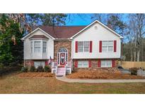 Charming two-story home with a brick and vinyl facade, complemented by red shutters and a well-maintained lawn at 1074 Fieldstone Dr, Canton, GA 30114