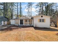 Charming renovated home featuring a white exterior, covered porch, and inviting curb appeal at 3333 Jackson Dr, Decatur, GA 30032