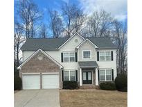 Charming two-story home with a brick facade, attached two-car garage, and well-maintained landscaping at 3305 Wickum Sw Rd, Atlanta, GA 30349