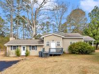 Charming single-story home featuring a cozy front porch and a well-maintained lawn at 583 Mount Zion Rd, Oxford, GA 30054