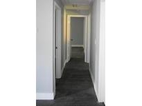 Hallway with grey walls and dark wood-look flooring leads to other rooms of the home at 814 Humphries Sw St, Atlanta, GA 30310