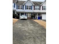 Charming two-story townhome featuring symmetrical design and private driveways with ample parking space at 430 Parkway Rd, Union City, GA 30291
