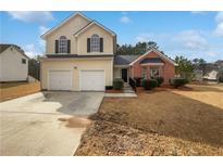 Charming two-story home with a two car garage and well-maintained front yard at 2928 Lakewater Way, Snellville, GA 30039