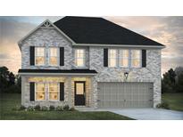 Charming two-story home with gray brick, black shutters, covered porch, and an attached two car garage at 367 River Walk Farm Lot 8 Pkwy, Covington, GA 30014