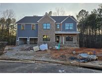 New two-story home with brick and siding, and an attached two-car garage under construction at 3687 Thornhill Ct, Douglasville, GA 30135