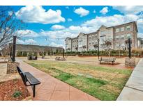 Inviting community area features benches, string lights, green space, and charming architecture at 4360 Sims Park Overlook, Suwanee, GA 30024
