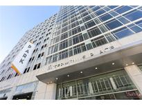 Exterior view of Terminus Place showing large windows, a parking sign, and the building's street-facing entrance at 3325 Peachtree Ne Rd # 1502, Atlanta, GA 30326