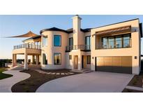 A modern, two-story home with a curved entrance, multiple balconies and a spacious driveway at 362 Old Ivy Ne Rd, Atlanta, GA 30342