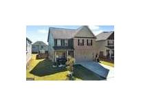 Two story home with well maintained lawn, grey siding, and dark shutters at 6048 Prodigy Ln, Locust Grove, GA 30248
