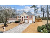 Charming two-story home featuring a brick and stucco facade with a well-manicured front yard and a two-car garage at 2275 Perch Sw Way, Marietta, GA 30008