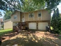Two story home with a two car garage and wooden steps at 975 Memory Ln, Lawrenceville, GA 30044