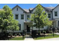 Charming two-story townhome featuring a black fence, neat landscaping, and an inviting entrance at 353 Vista Ln, Woodstock, GA 30189