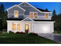 Charming two-story home with white brick, blue siding, manicured lawn, and attached two-car garage at 367 Denali Butte Ter, Canton, GA 30114