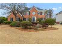 Charming two-story brick home featuring manicured landscaping and a classic architectural design at 2541 Berwick Walk, Snellville, GA 30078