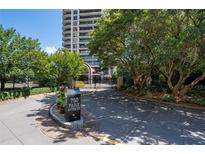 View of the building's gated entrance on a sunny day at 750 Park Ne Ave # 21E, Atlanta, GA 30326