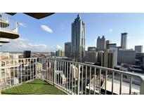 Stunning balcony view of the city skyline from a high-rise apartment with clear sky and modern railings at 400 W Peachtree Nw St # 2808, Atlanta, GA 30308