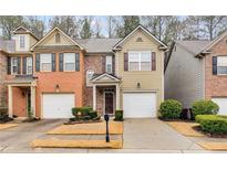 Charming townhome with manicured lawn, one-car garage, and inviting curb appeal at 3349 Thornbridge Dr, Powder Springs, GA 30127