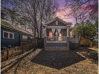 Charming exterior elevation of home with covered porch and landscaped yard at 1530 Oakview Rd, Decatur, GA 30030