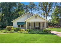 Charming single-story home with a lovely screened-in porch and well-maintained lawn at 3551 Lavista Rd, Decatur, GA 30033